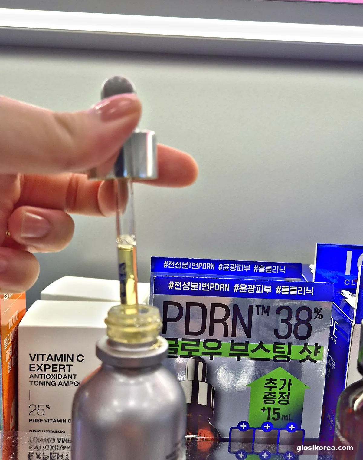 IOPE Vitamin C Expert 25% ampoule dropper showing the yellow texture