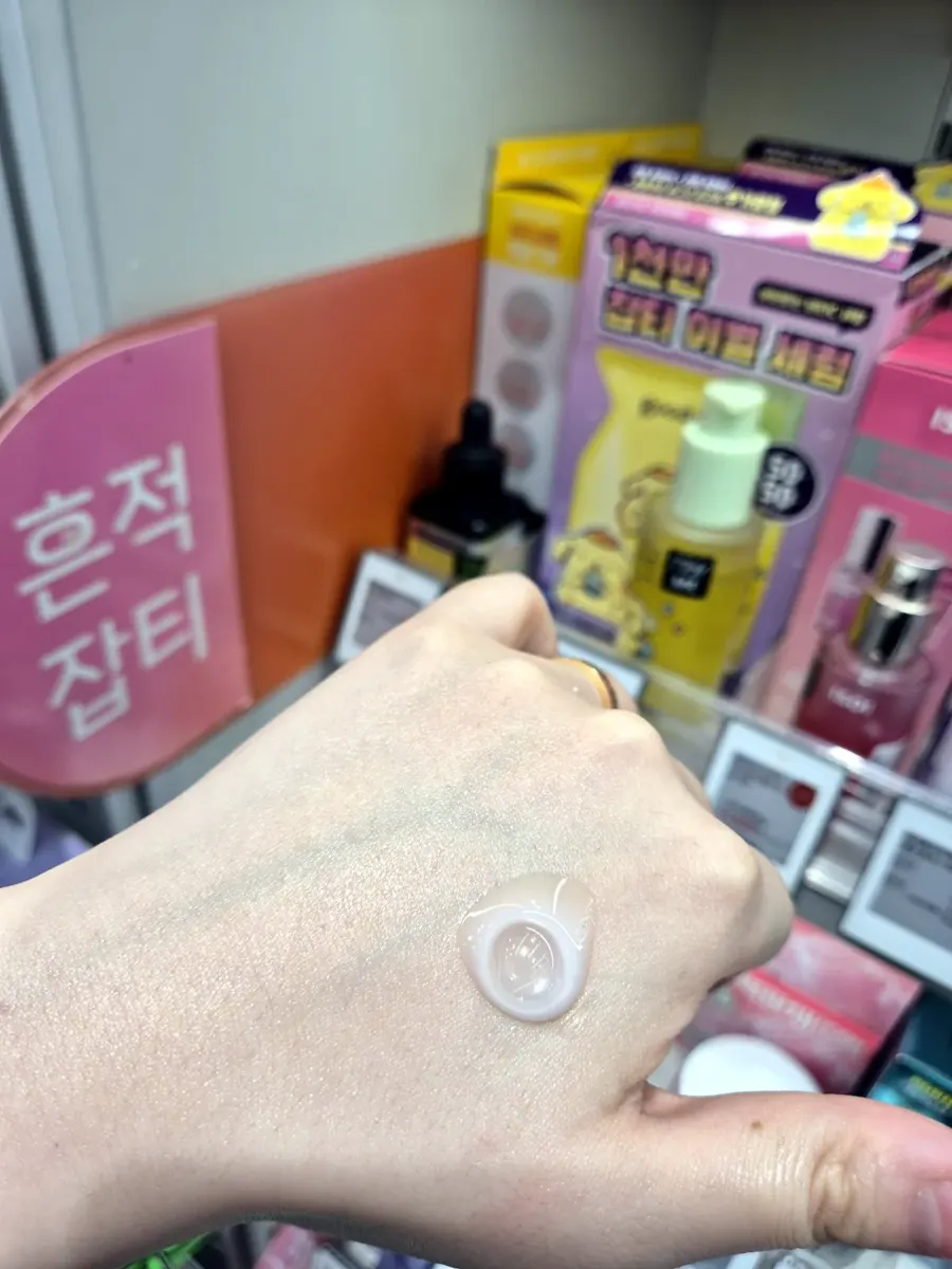 MEDIHEAL PDRN Pore Serum swatch on hand, slightly milky texture