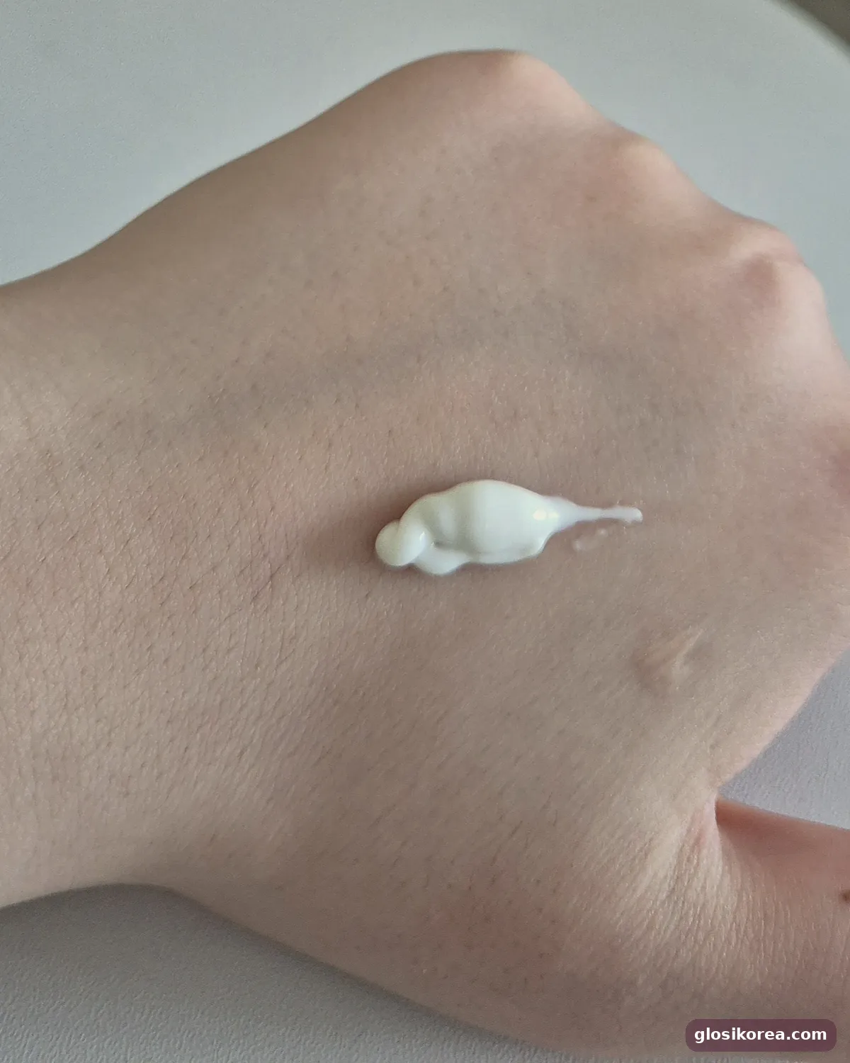 A dot of Dr.G R.E.D Blemish Soothing Up Sun on the back of a hand