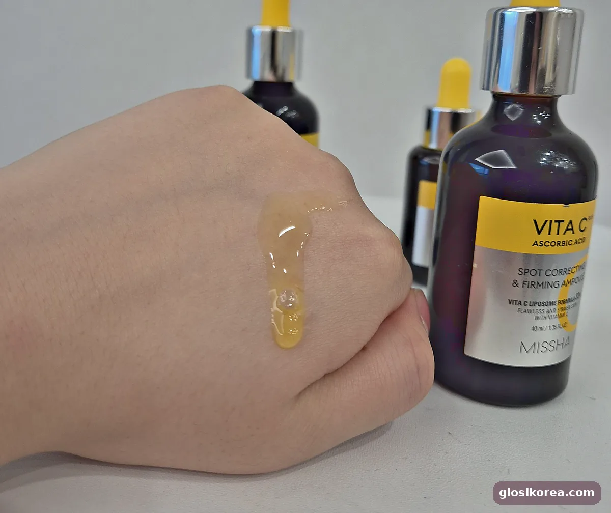 MISSHA Vita C Plus ampoule drop on the back of a hand next to the bottle