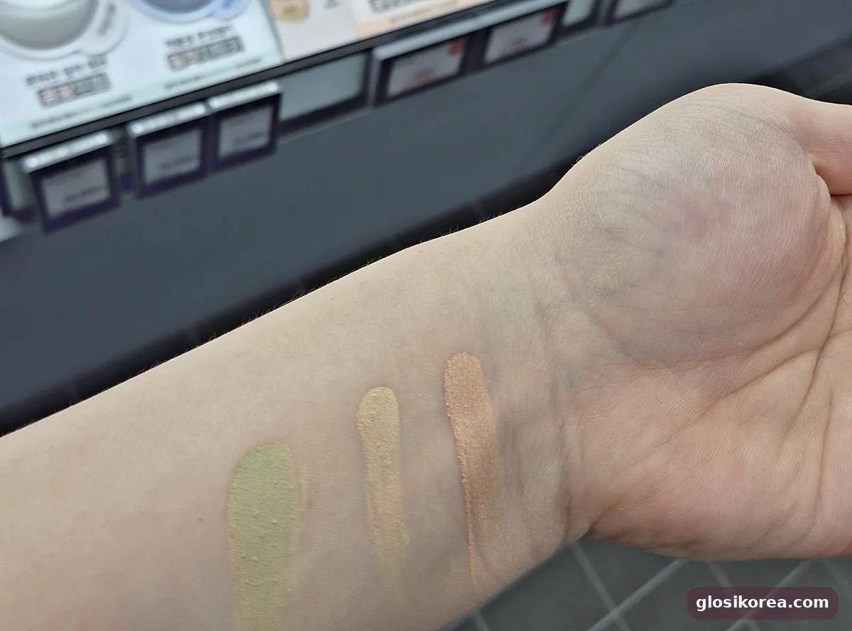 The Saem Triple Pot Concealer swatches on the arm: green, beige and peach