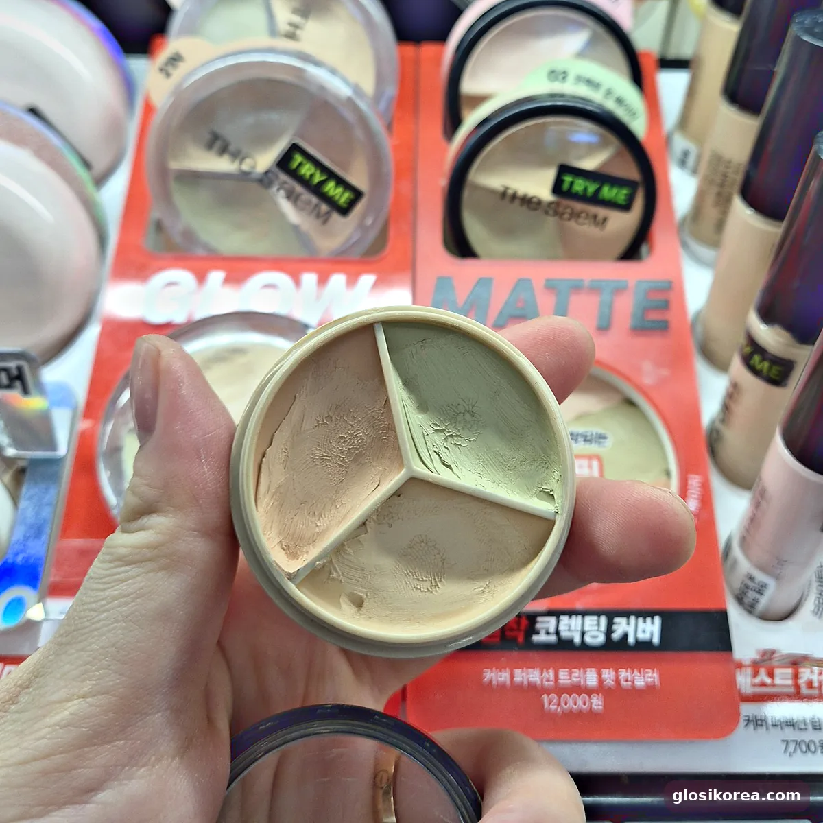 The Saem Triple Pot Concealer opened, showing the green, beige and peach colors